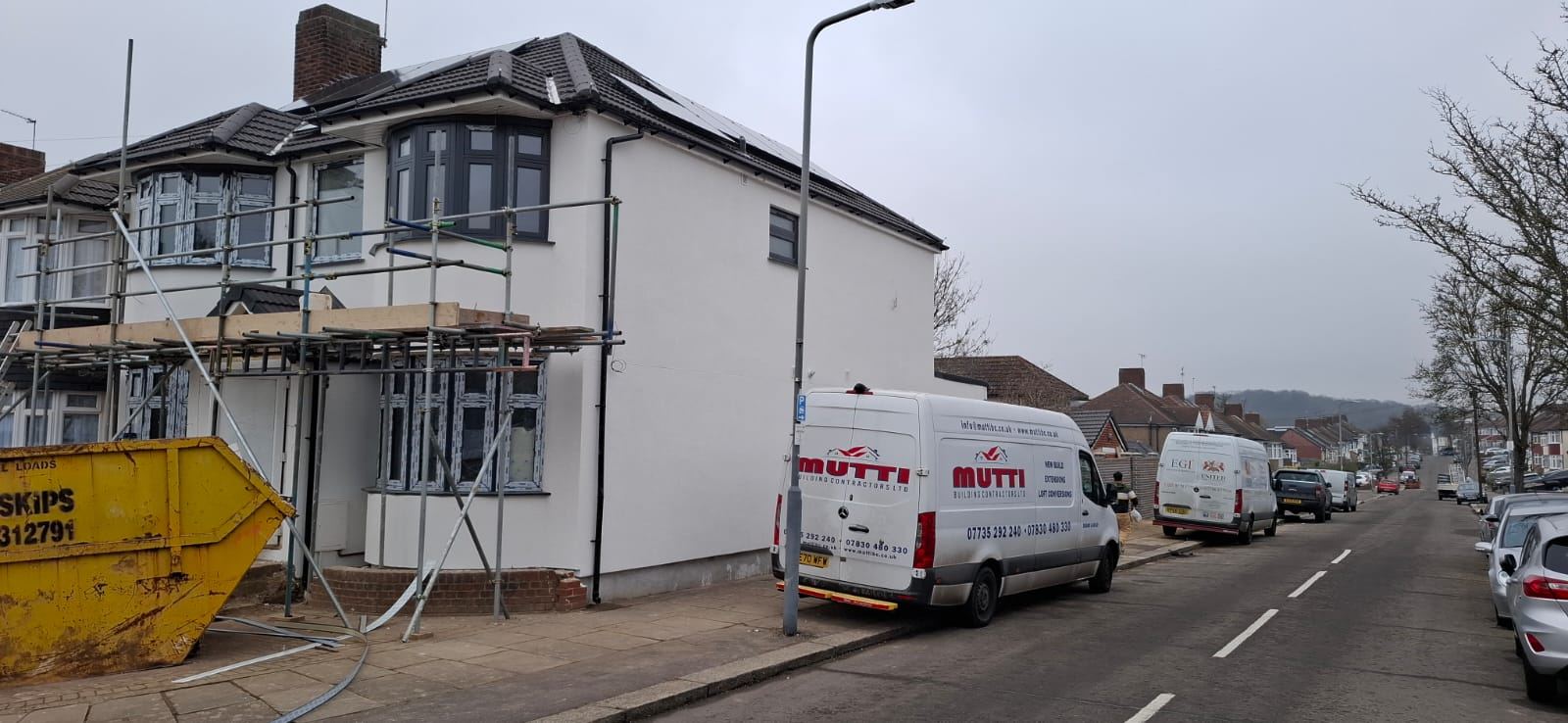 Mutti Building Contractors van and scaffold on a residential extension job in London