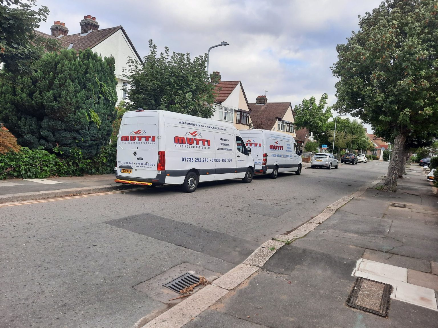Two Mutti Building Contractors vans parked on site in East London
